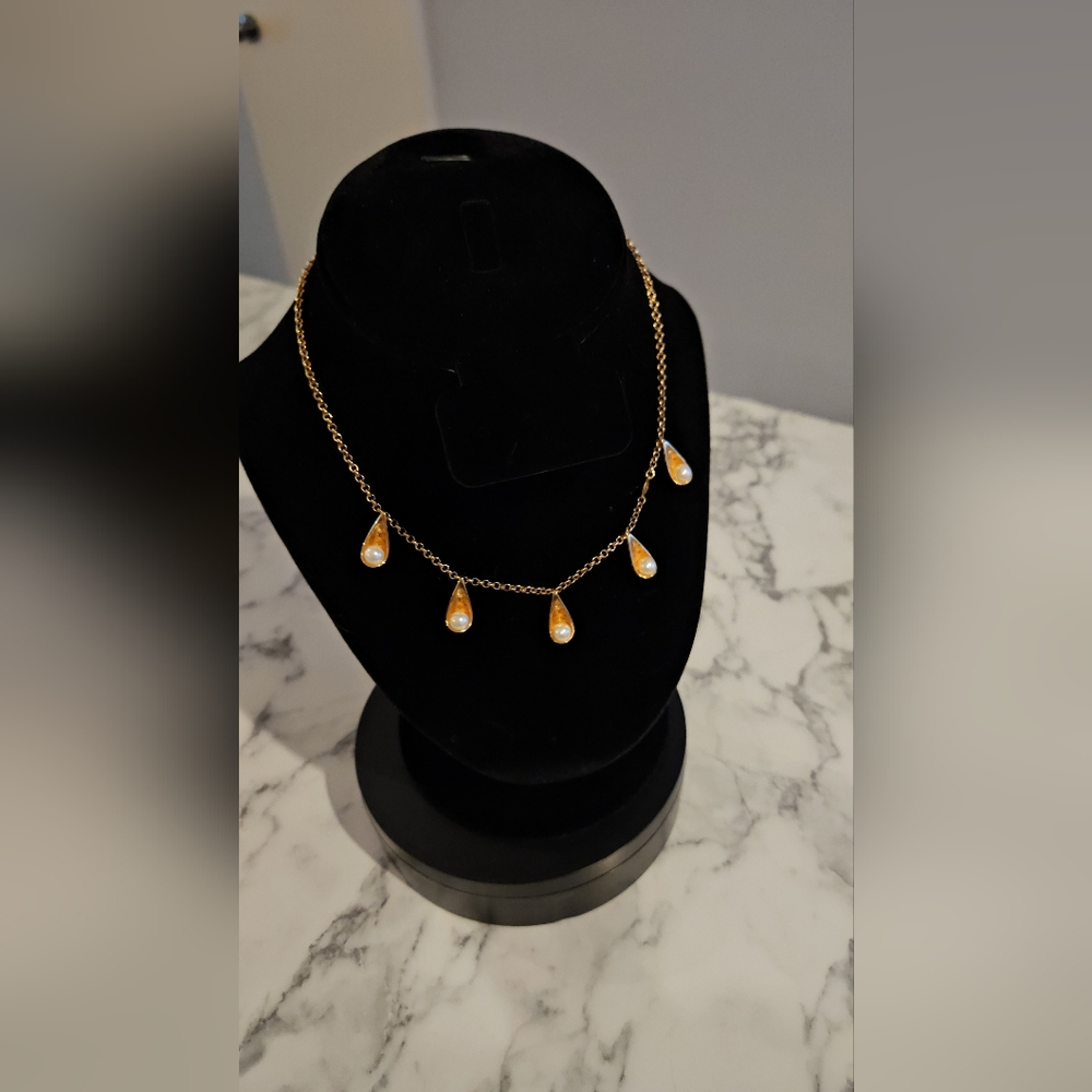 Louis Vuitton elegant gold and pearl necklace.